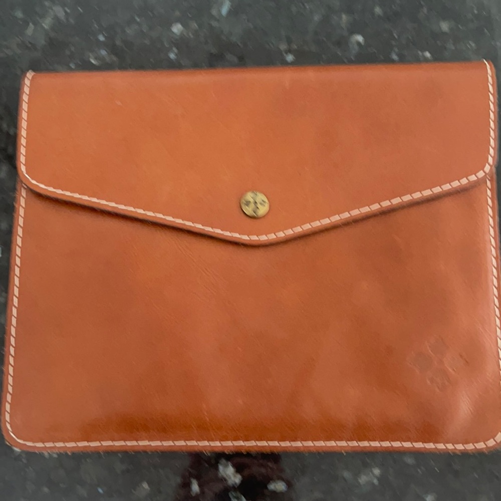 Leather snap closure clutch with back zip pocket